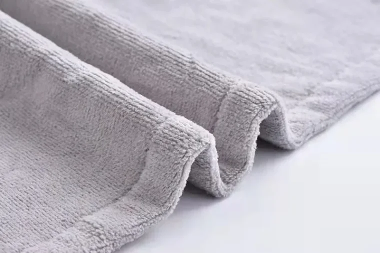 Close-up view of a knitted fabric with intricate cable patterns